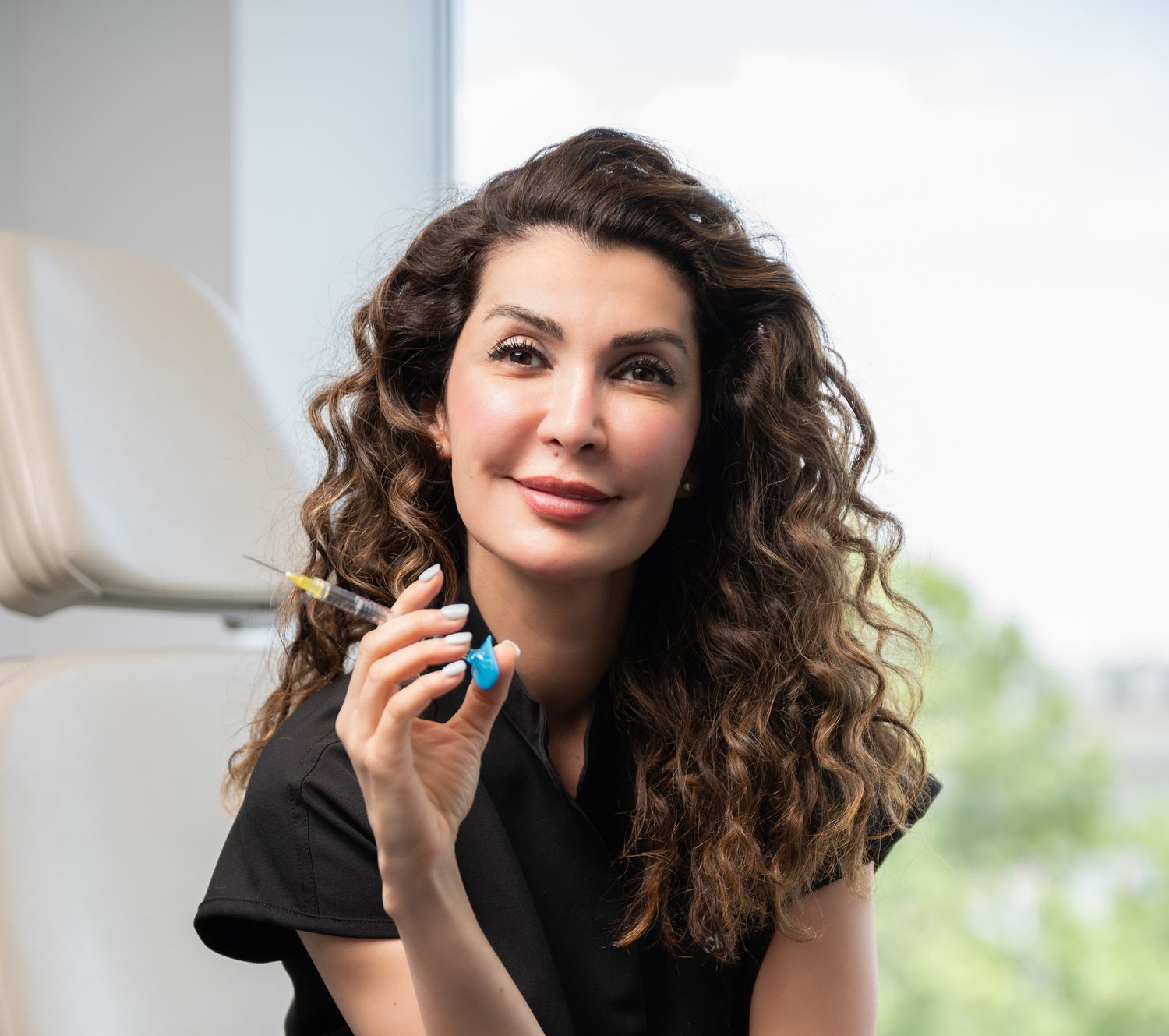 Professional woman holding syringe and vial.