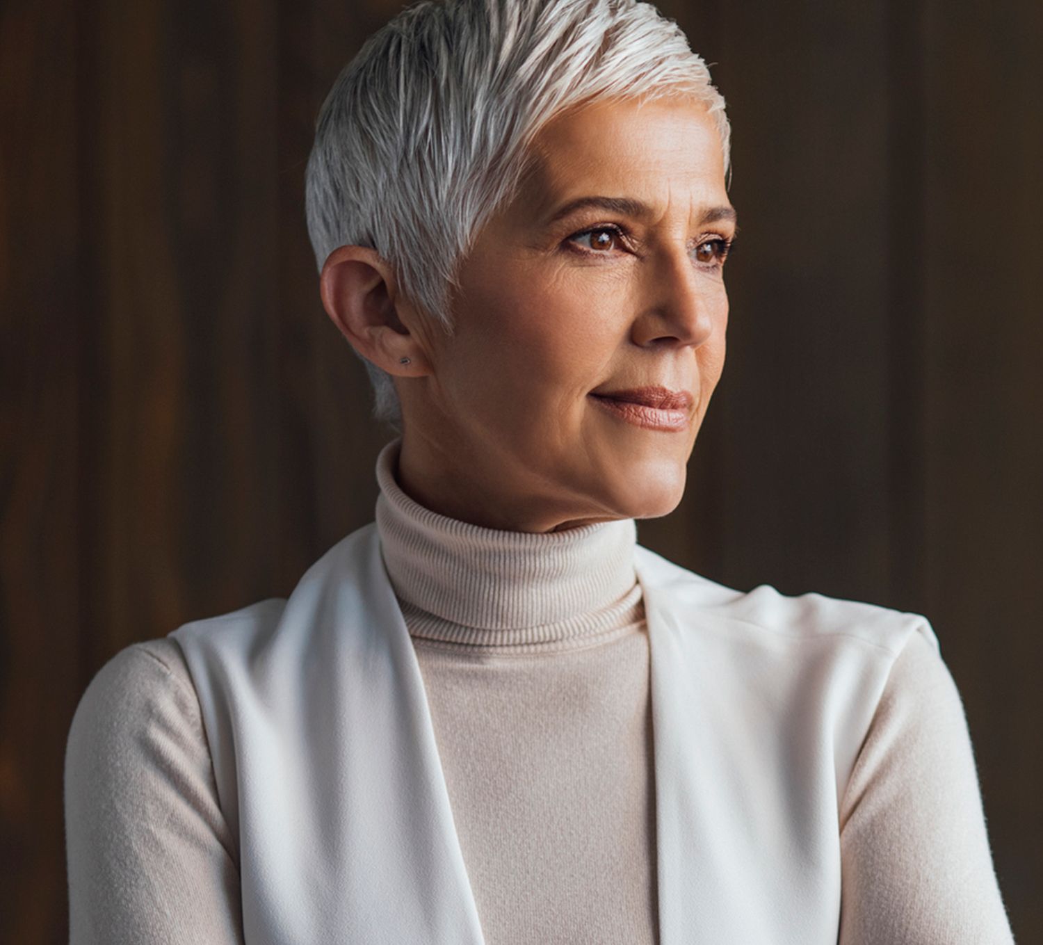 Woman with short hair, wearing a turtleneck sweater.