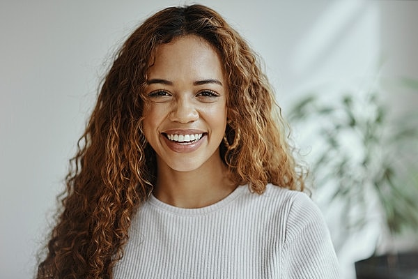 Close-up of a woman with curly hair.