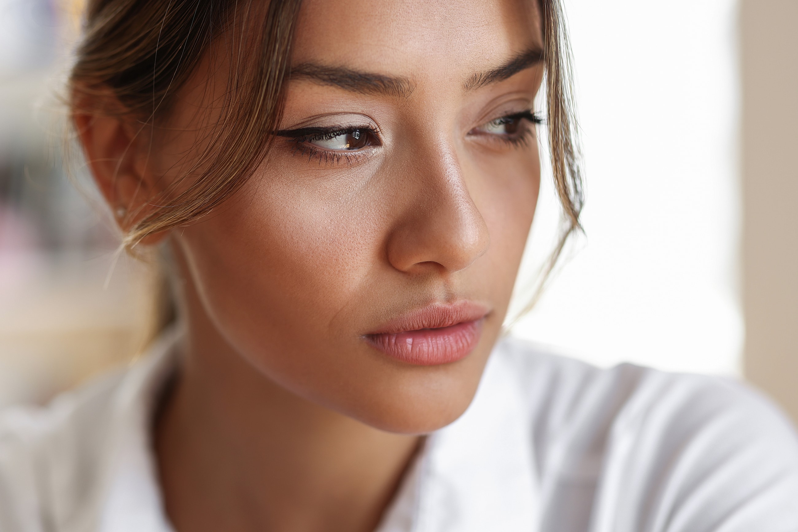 Close-up of a thoughtful woman with natural beauty.