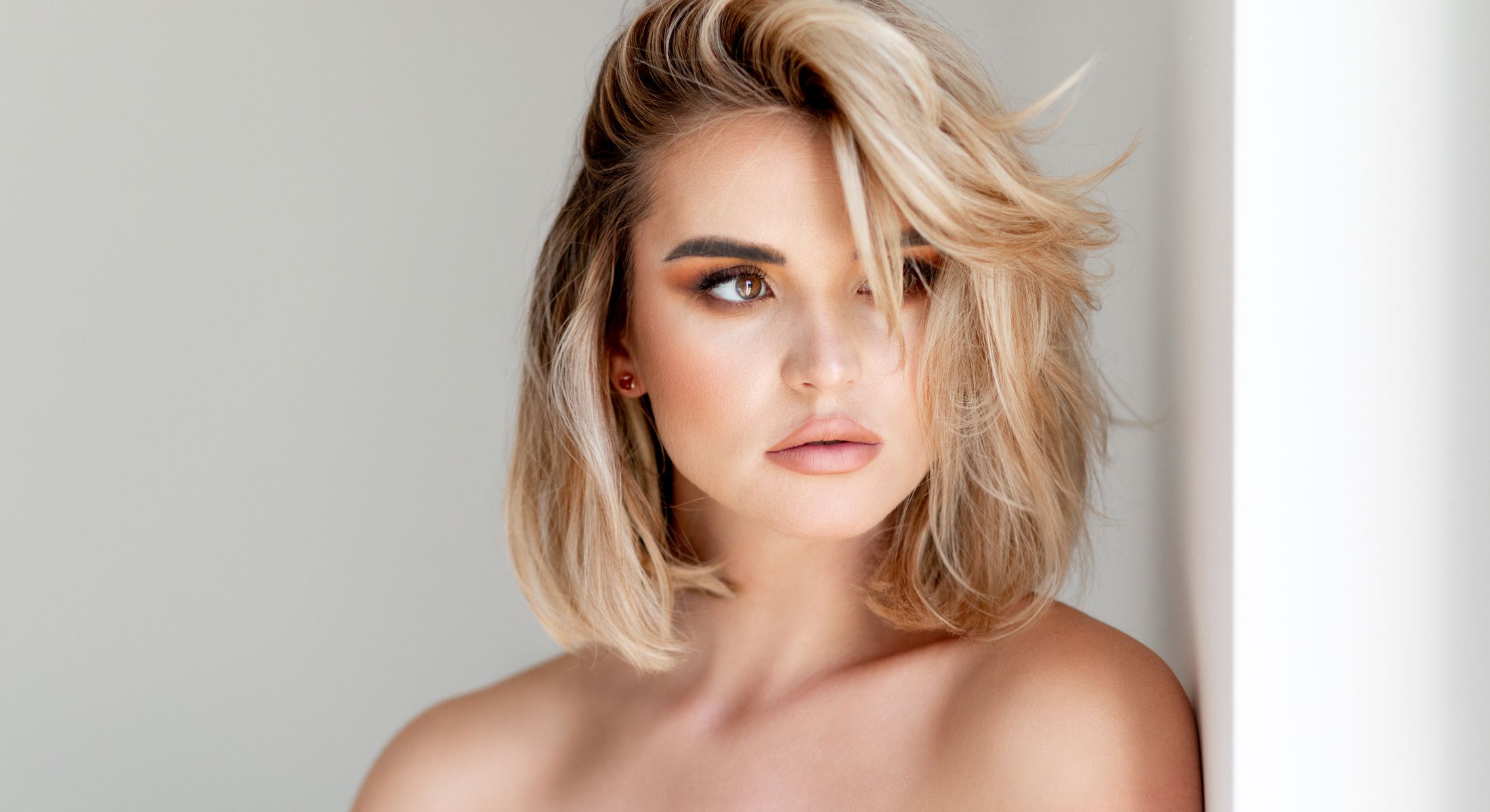 Woman with blonde hair and natural makeup.