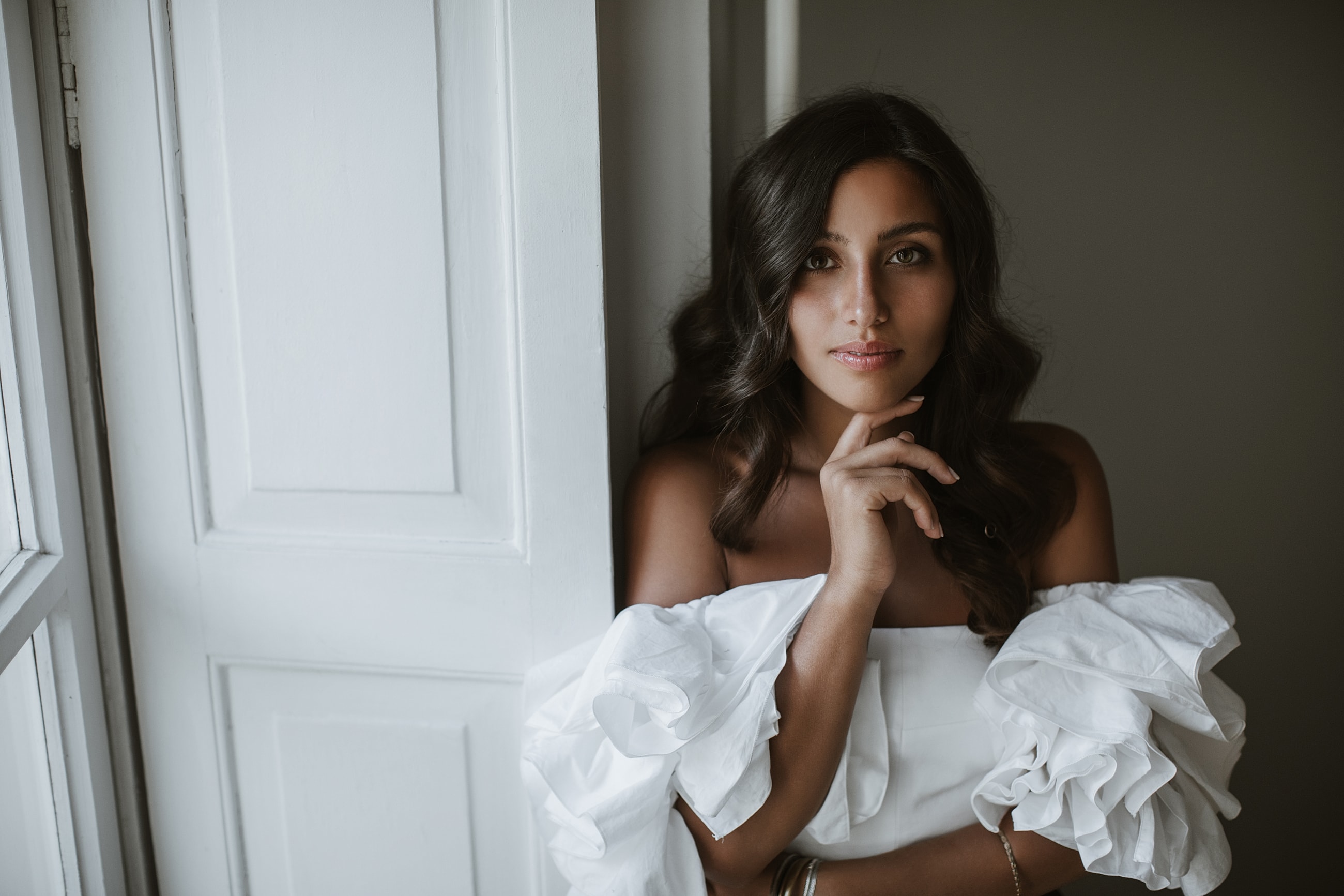 Woman in elegant backless dress outdoors.