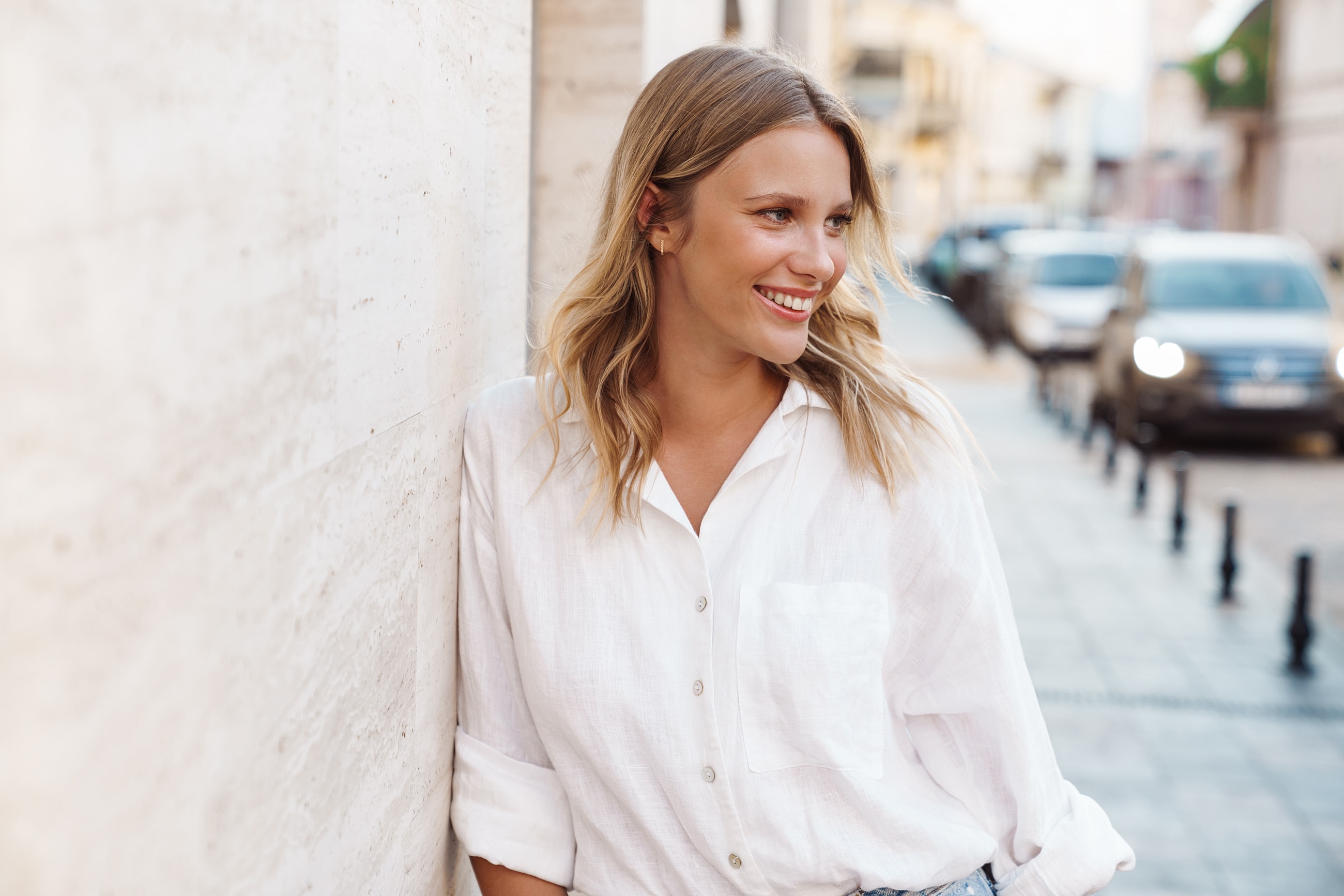 Smiling woman in a casual white shirt.
