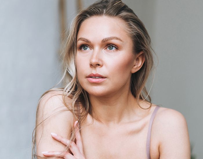 Woman with long hair gazing thoughtfully.