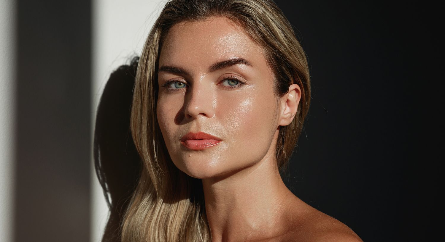 Natural light portrait of a woman with glowing skin.