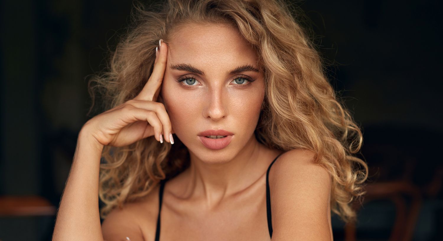 Portrait of a woman with curly hair.